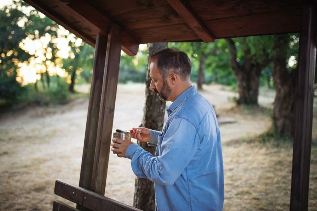 Photo of man painting a gazebo in the park Pergola and Gazebo Staining